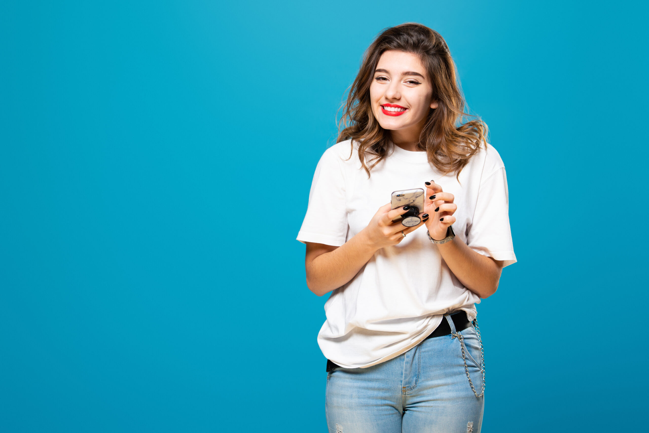 Girl,With,A,Phone,In,Her,Hands,Smiles,,Isolated,On